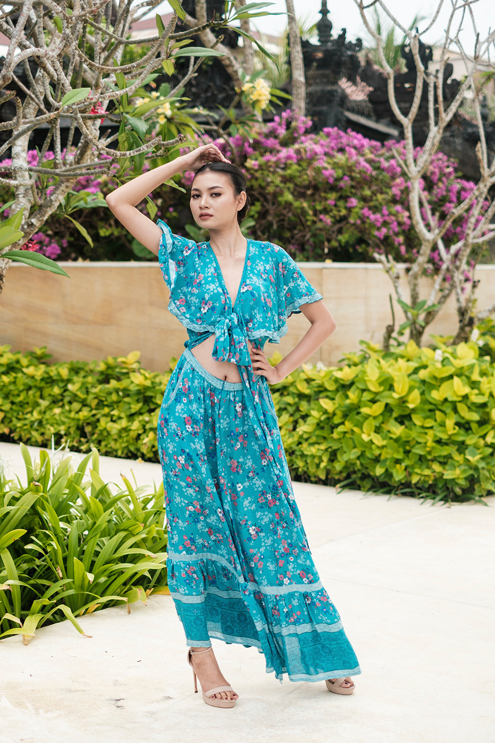The Tumi Cape Dress by Tulle and Batiste, handmade by skilled Balinese artisans, showcasing intricate craftsmanship.