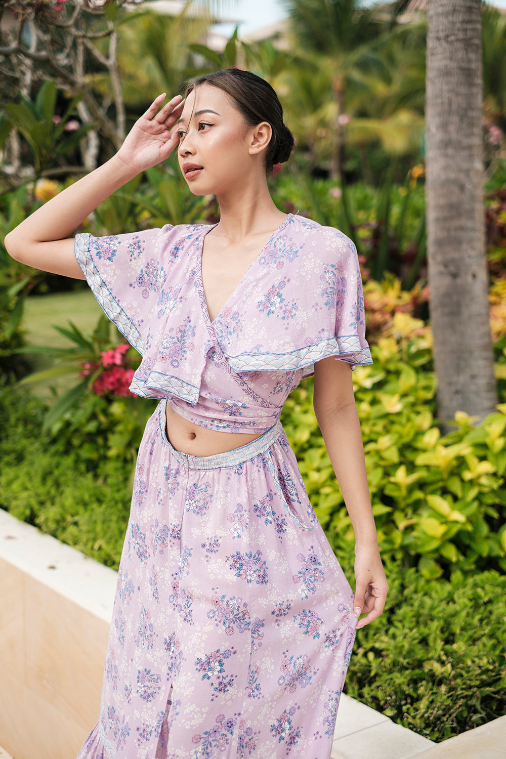 The Tumi Cape Dress by Tulle and Batiste, handmade by skilled Balinese artisans, showcasing intricate craftsmanship.