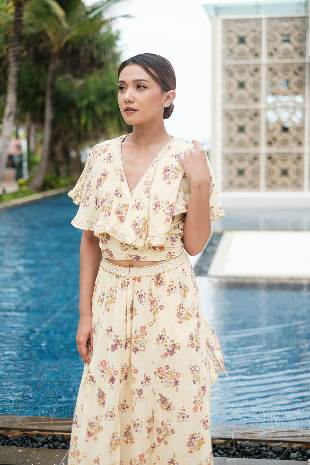 The Tumi Cape Dress by Tulle and Batiste, handmade by skilled Balinese artisans, showcasing intricate craftsmanship.