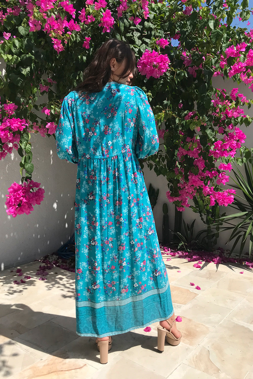 The handmade Roseanne Boho Dress in Capri Blue by Tulle and Batiste, featuring a button-through design, custom tailored options, and signature pockets.
